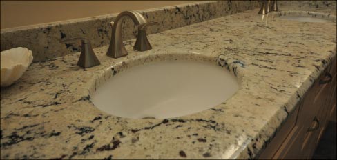 White Eyes Granite ties the vanity, shower seat and trim together.   