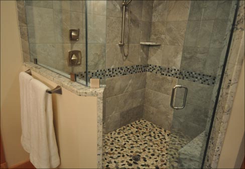 White Eyes Granite ties the vanity, shower seat and trim together.   