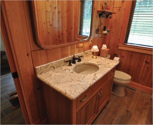 Copenhagen Granite was chosen to complement the warm, wood tones of the chalet’s rustic powder room.