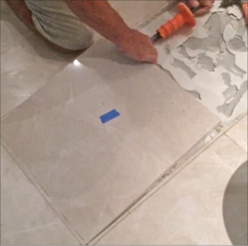 He finished his last cut and the tile popped up.