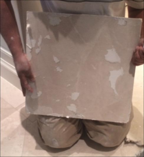 He flipped it over– and surprise, surprise – There wasn’t any mortar on the back of the tile