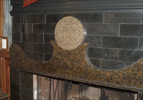 Much of the interior stonework is from recycled or reclaimed remnants, saved up over years. The curved fireplace surround and round cut-out are themes repeated in different rooms.