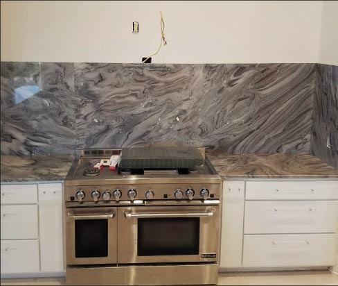 Shown with installation in progress: pattern-matched quartzite top and splash. 