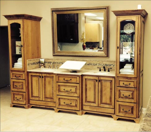 Sample double sink vanity features a custom backsplash with inset mosaic tile. Stone Interiors also offers tile work, focusing on backsplashes, wet areas and showers. 