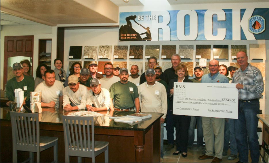 The Rocky Mountain Stone team presents a check to The Rock at Noonday – the Alex Fund, an Albuquerque, New Mexico charity that provides food for the homeless and hungry, five days a week.