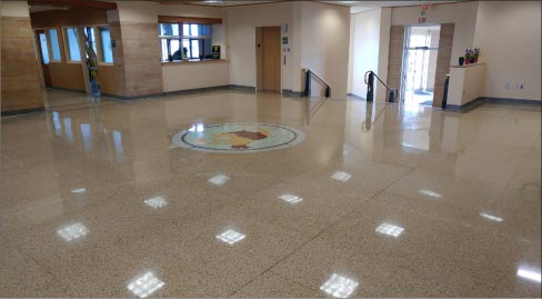 After stripping the finish, grinding and polishing, the restored terrazzo floor is restored to its former glory.