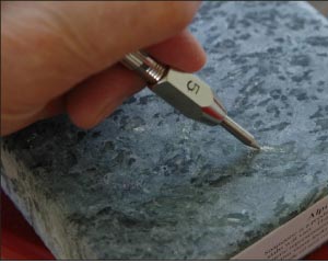 Alpine soapstone contains talc, easily scratched with a number 2 pick.