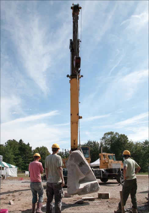 Crane operator Jim Salisbury (Jesse’s Dad) has some serious concentration in his eyes as he carefully and safely flips over the sculpture of Artist Miles Chapin of Maine.