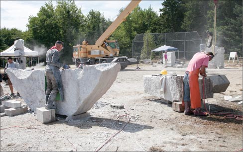 Sculpture Assistant Wesley Nibling of New Hampshire is shown helping Washington Artist, Robert Leverich with his multiple piece sculpture destined for Castine, Maine. Leverich is well known for his prowess of hammer and chisel and large-scale work. “The basis of our mission is to encourage artists to elevate to this international level of artistry. It is a great opportunity for the artists to further hone their already high skill levels while working alongside other accomplished artists, and a chance to create a major work of public art to be displayed in Maine.”  — Tilan Copson