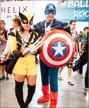 Photo from the San Diego Comic Con, held July 18-21, 2013, shows cosplaying couple dressed as Marvel comics characters Captain America and Wolverine. Many ComicCon characters construct and dress in elaborate costumes as a tribute to a favorite character.