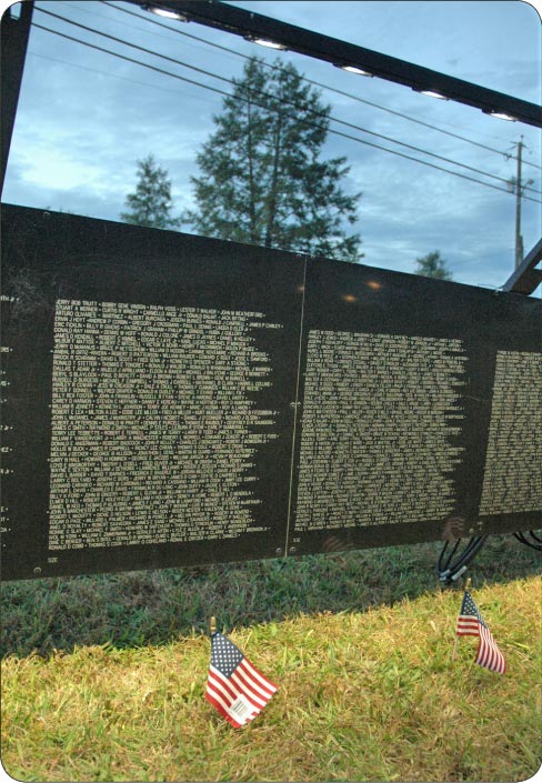 Johnson said the hundreds of flags planted in front of the wall were all brought by visitors, who also often leave mementos that are saved and become part of a special traveling collection.